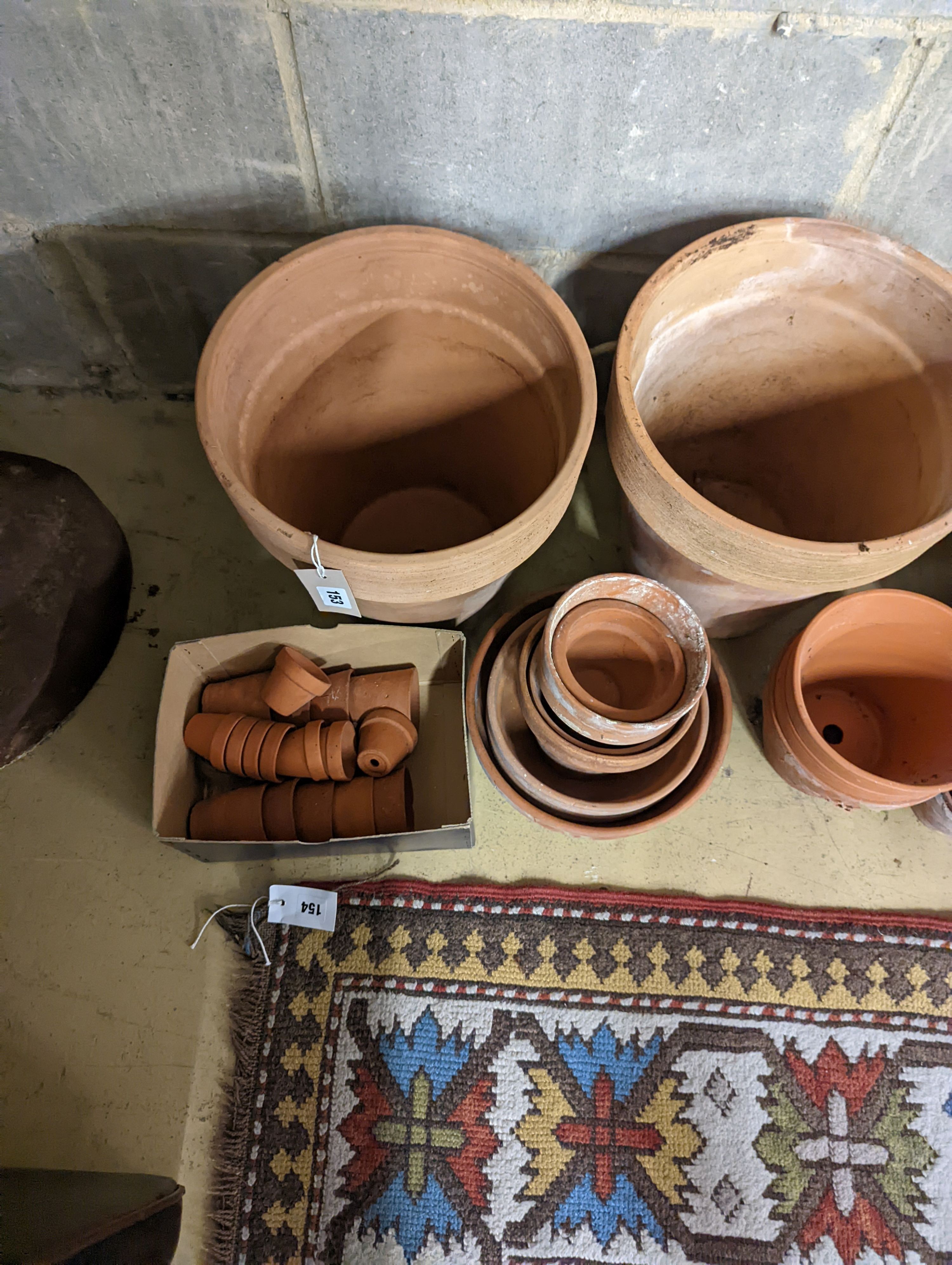 A collection of approximately 40 assorted terracotta planters, largest diameter 32cm